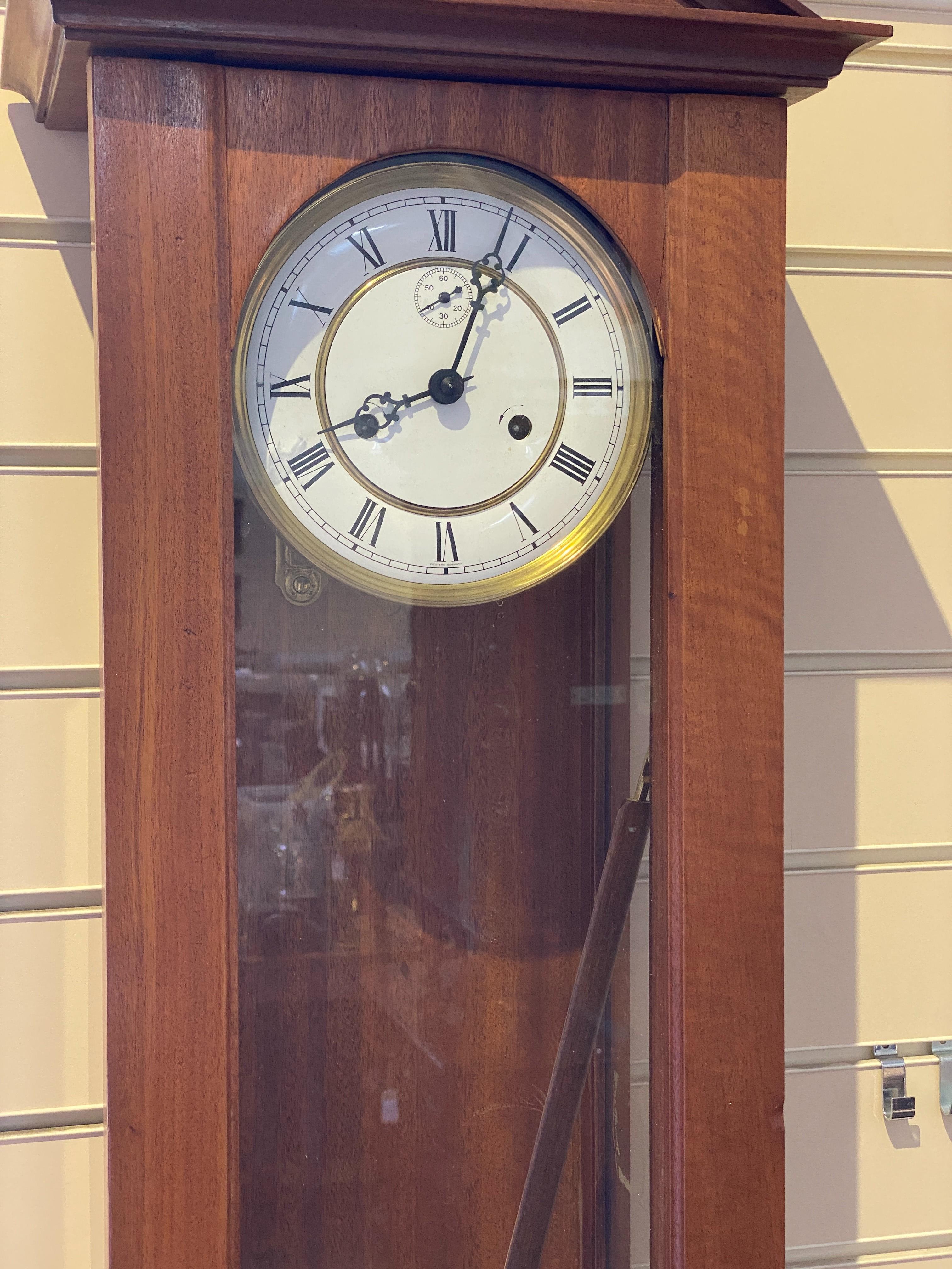 A mid 20th century mahogany Vienna type 8 day wall clock the circular white enamel dial with subsidiary seconds, height 112 cms.